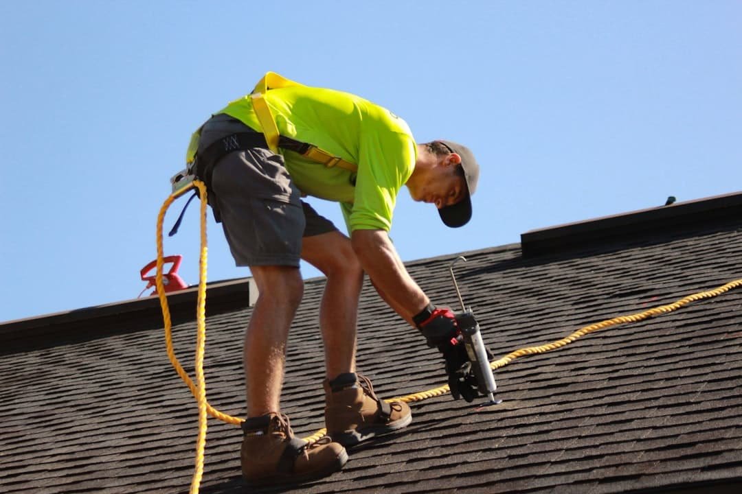services-03 a-man-working-on-a-roof-with-a-power-drill-acnfstblnts
